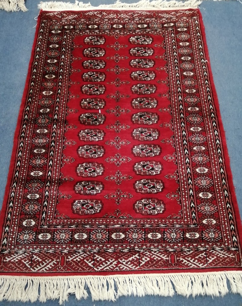 A Bokhara red ground rug, 145 x 100cm